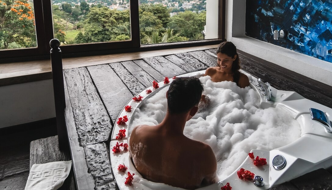 Couple relaxing in jacuzzi on honeymoon at Theva Residency Kandy