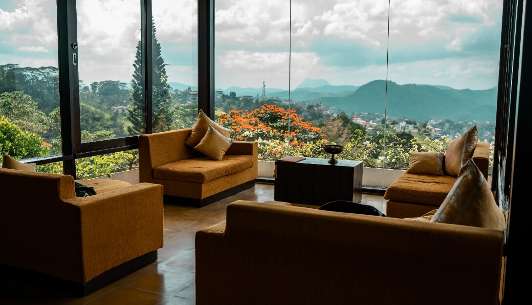 Relaxing living area with nature views at Theva Residency Penthouse
