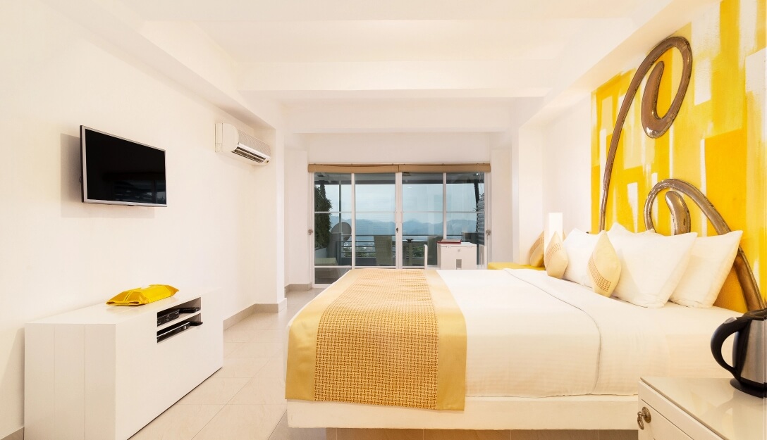 Elegant Superior Mountain Room with yellow interior at Theva Residency