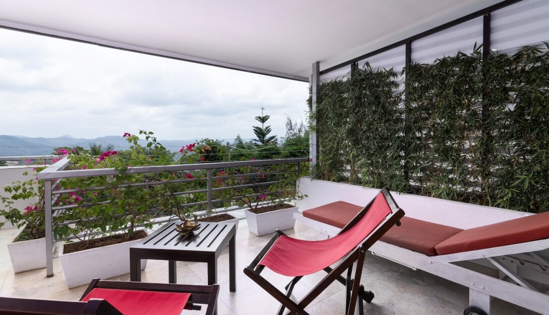 Balcony with mountain views in superior ground room at Theva Residency