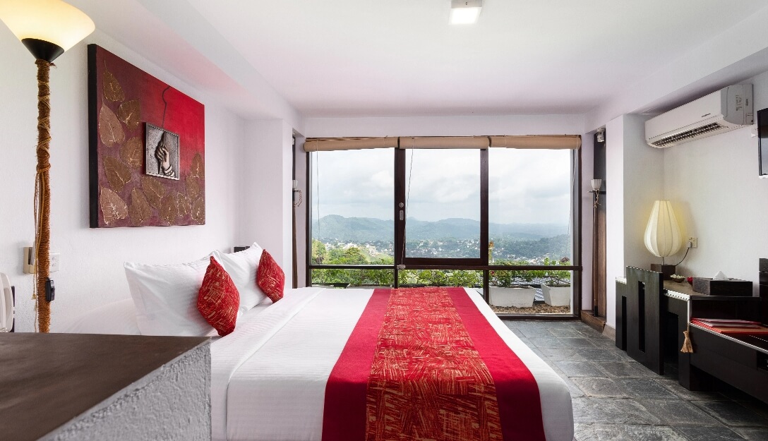 Elegant deluxe room with mountain views at Theva Residency Kandy