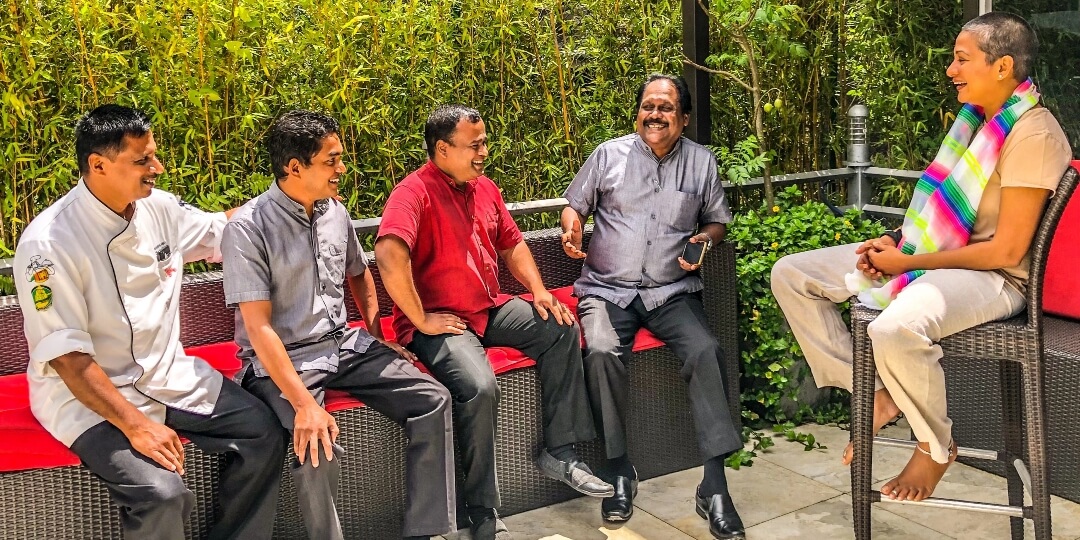 Staff enjoying a lively discussion at Theva Residency Kandy