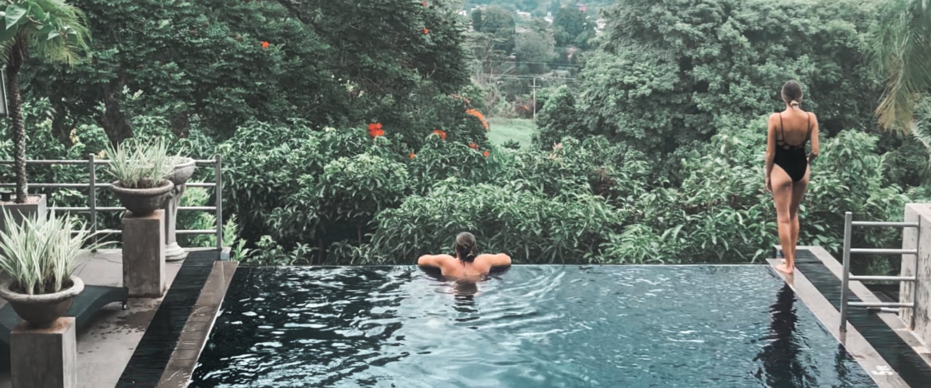 Serene infinity pool with lush nature views at Theva Residency